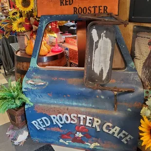 a blue truck with a sign that says the red rooster cafe