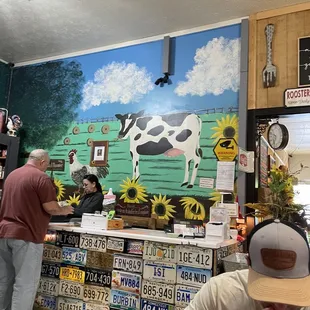 License plates and cow mural. Check out counter