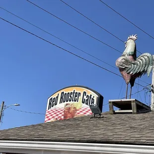 a rooster on the roof of a restaurant