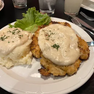 Chicken fried chicken and mashed potatoes.