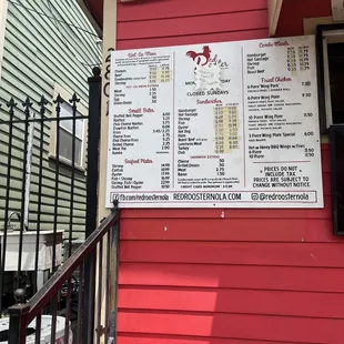 a menu on a red building