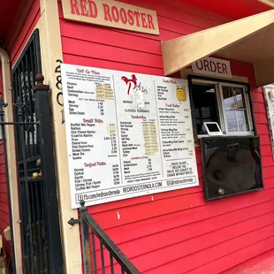 a menu on a red building