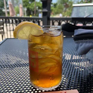 a glass of iced tea on a table