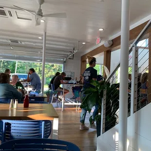 people sitting at tables in a restaurant