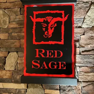 a sign on a brick wall