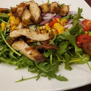 a plate of salad with chicken and vegetables