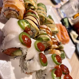 a plate of sushi and rolls