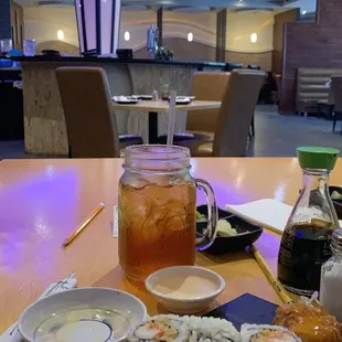 a table with sushi and drinks