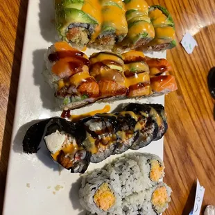 a variety of sushi on a white plate