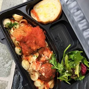 Spaghetti and meatballs with salad and bread