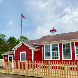 a red school building with a flag on top