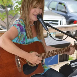 a woman playing a guitar