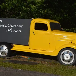 a yellow truck with a sign on the back