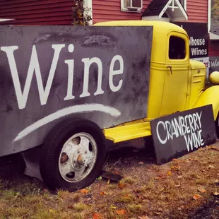 a yellow truck with a sign that says wine