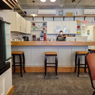 a counter with stools in front of it