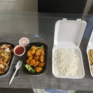 three takeout containers of food
