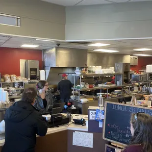 customers in a restaurant kitchen
