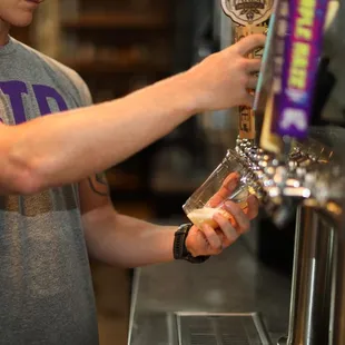 a man pouring a beer