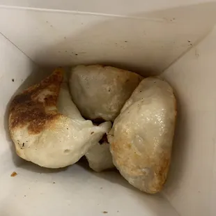 three dumplings in a white box
