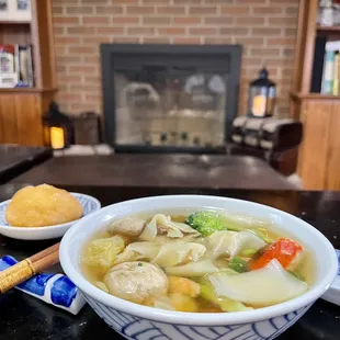 a bowl of soup and bread on a table