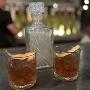 two glasses of alcohol and a decanter