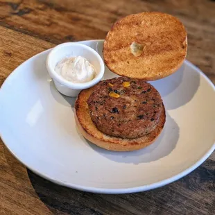 a plate with a sandwich and a bowl of sour cream