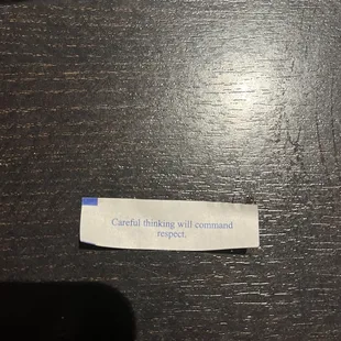 a note on a wooden table