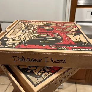 two pizza boxes stacked on top of each other