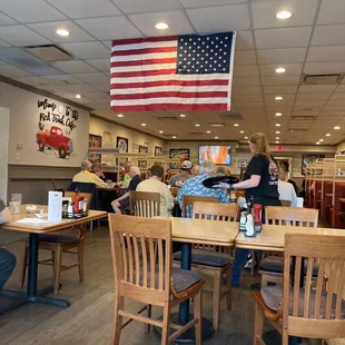 people sitting at tables and eating