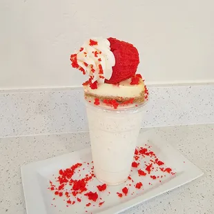 a red velvet milkshake with whipped cream and sprinkles