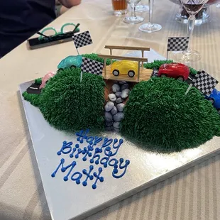 Cake cut in half and laid on side. I supplied the cars and flags.