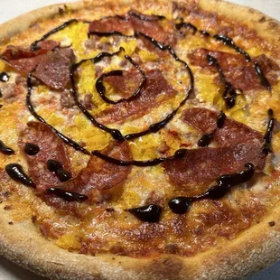 RED WAGON PIZZA (DDD) Red sauce, sopressata, banana peppers, cheese, sausage, chili flakes, garlic salt, &amp; fig balsamic.