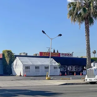 a truck parked in front of a restaurant