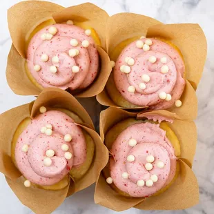 Strawberry 'n Cream: Vanilla bean cupcake with strawberry white chocolate buttercream and white chocolate sprinkles.