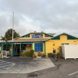 a yellow building with a bicycle parked in front of it