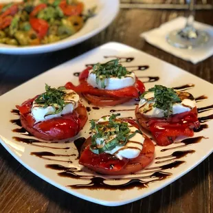 a plate of tomatoes with mozzarella