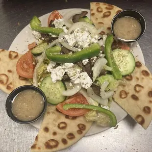 a plate of food with pita chips and vegetables