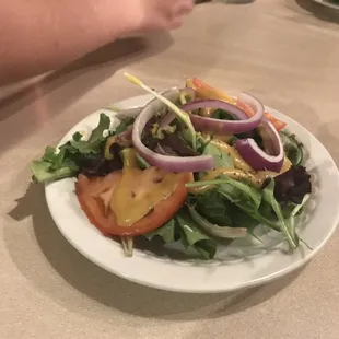 a white plate with a salad on it