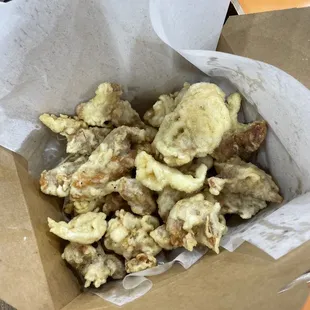 a paper bag filled with fried food