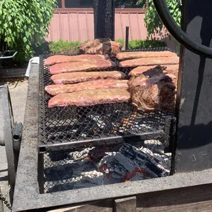 Open flamed wagon grill in front of restaurant