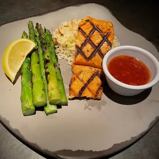 Grilled Salmon served with sweet chili sauce, rice pilaf and asparagus