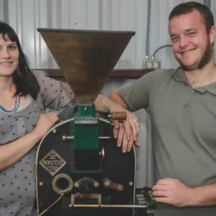 a man and a woman pouring coffee