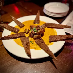 a plate of appetizers and a glass of wine