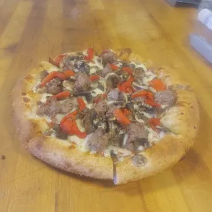 a pizza on a wooden table