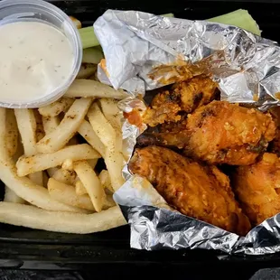 Buffalo (hot) wings with fries and ranch dipping sauce.