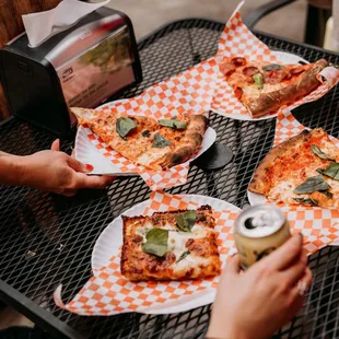 a group of people eating pizza