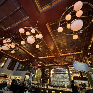 a bar with a lot of lights hanging from the ceiling