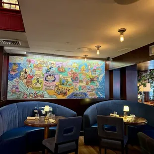 a restaurant with a colorful mural on the wall