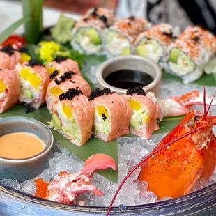 a platter of sushi and shrimp