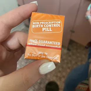 a person holding a condom in their hand